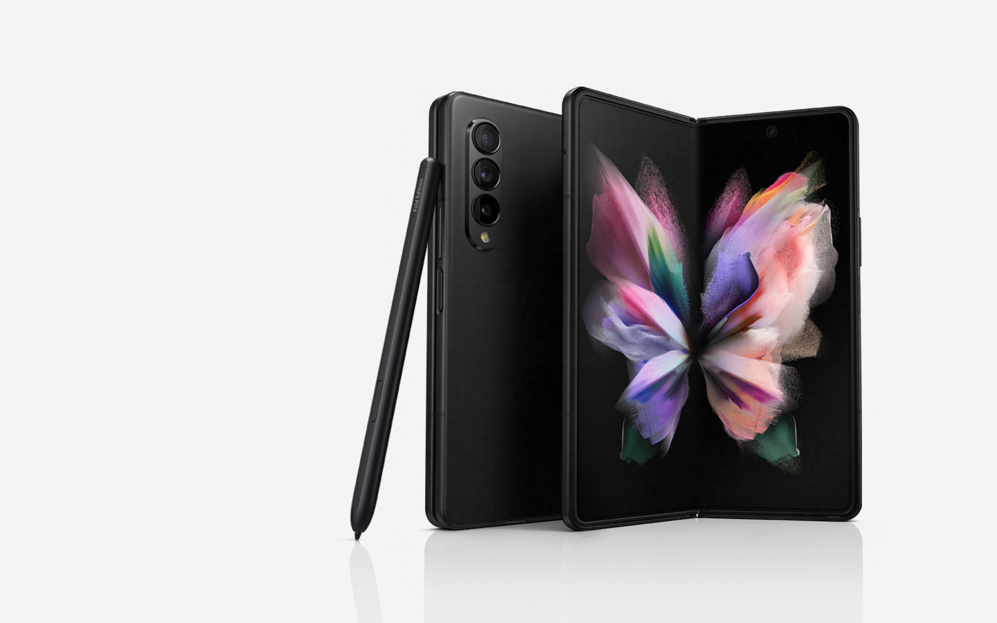 Two Galaxy Z Fold3 5G phones, one seen folded from the Back Cover and one seen unfolded with a colorful wallpaper on the Main Screen. The S Pen Fold Edition leans against the folded phone.